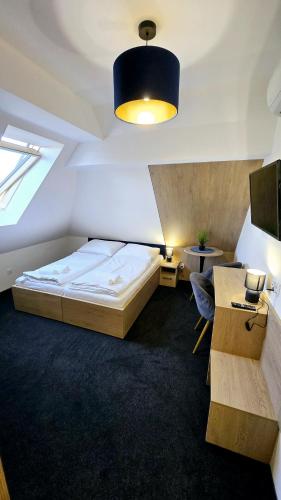 a bedroom with a bed and a desk and a tv at Cliff House & Restaurant in Żary