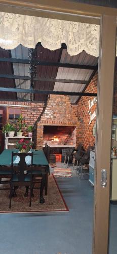 a dining room with a table and a brick fireplace at French Toast in George