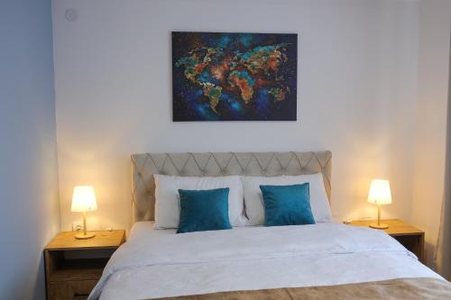 a bedroom with a large bed with two lamps at Apartmani Lepojevic in Prokuplje