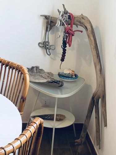 a table with a skeleton on it next to two chairs at Le maree in Grado