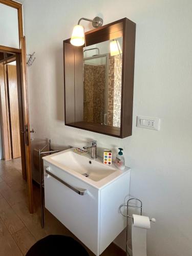 a bathroom with a white sink and a mirror at Le maree in Grado