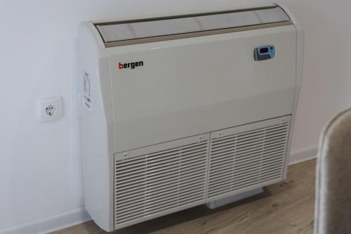 a white air conditioner sitting in a room at Apartmani Lepojevic in Prokuplje