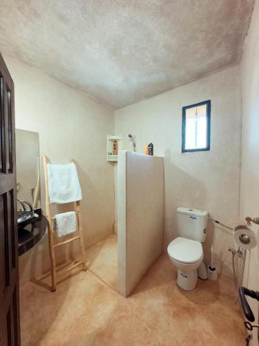 ein Badezimmer mit Toilette und Fenster in der Unterkunft Atlas Agafay Horizon Marrakech Auberge & Luxury Suites in Aquine-Mazouz