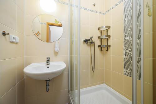 a bathroom with a sink and a shower at Wellness Hostel Central in Prague