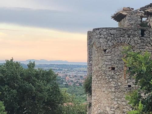a stone tower with a view of a city at Il Campanile in Fondi