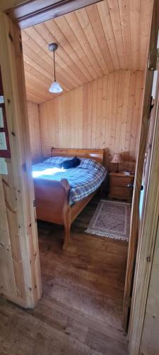 a bedroom with a bed in a wooden cabin at Beautiful Cabin near Radium Hot Springs with private hot tub in Radium Hot Springs