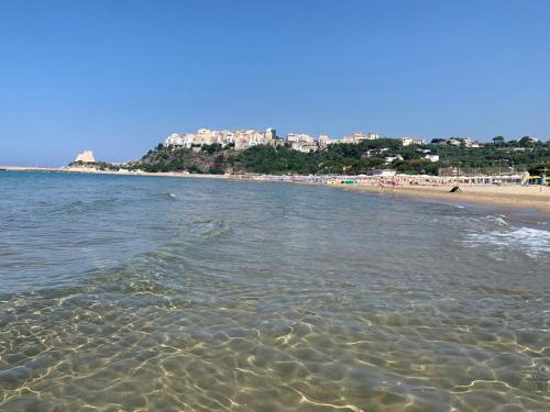 a view of a beach with a city in the background at Il Campanile in Fondi