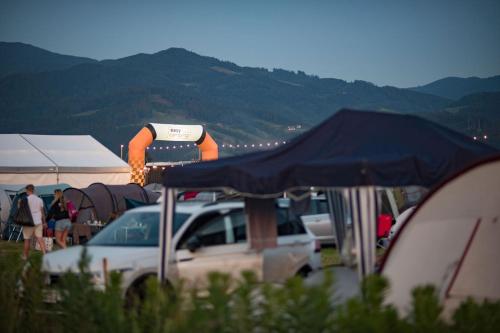 a car parked in a parking lot with tents at Easy Camping in Spielberg
