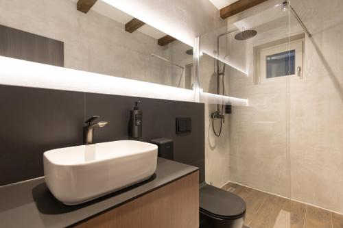 a bathroom with a white sink and a shower at Agara Stays Prizren in Prizren