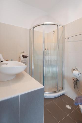 a bathroom with a sink and a shower at Aggeliki's House in Kamarai