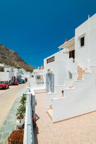 a view of the side of a white building with stairs at Aggeliki's House in Kamarai