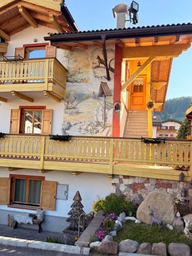 a house with a mural on the side of it at Casa mia - vall di fassa in Vigo di Fassa