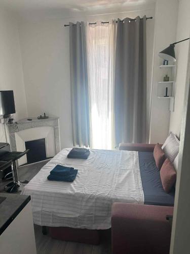 a bedroom with a bed with two pillows on it at joli studio en face de la gare in Nice