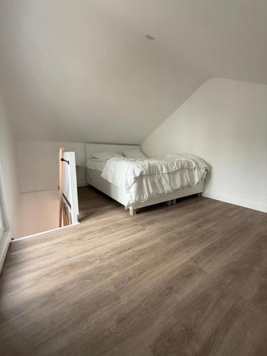 a bedroom with a bed and a wooden floor at Residence du bois 2 in Mitry-Mory
