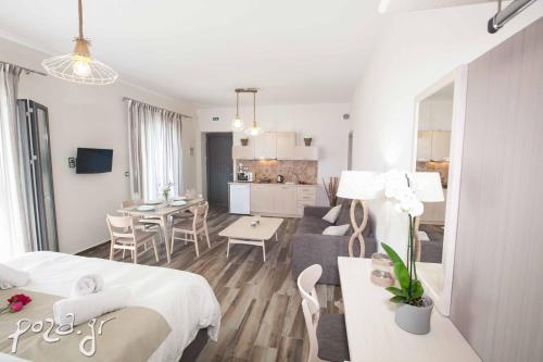 a bedroom and living room with a bed and a couch at Petra Thea in Kalamata