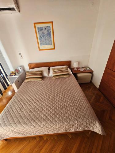a bedroom with a large bed in a room at " Rooms Bela" balcony in Ičići