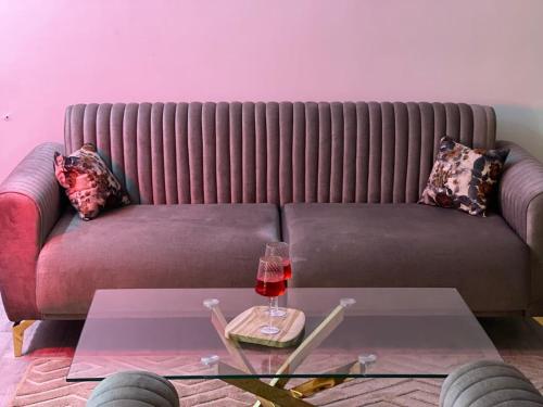 a living room with a couch with a glass table at ZENHOME luxury appartement in Dilida