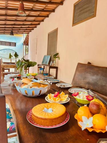 a wooden table with food on top of it at Pousada Caraíva dos Sonhos Oficial in Caraíva