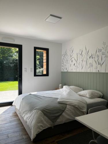 a bedroom with a large bed and a window at Maison Osithe in Doudeauville