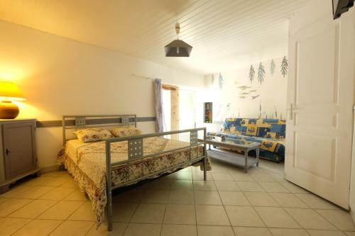 une chambre avec un lit et une table dedans dans l'établissement Soleil Levant, petite maison de caractère à prix bas, à Saint-Georges-de-Pointindoux