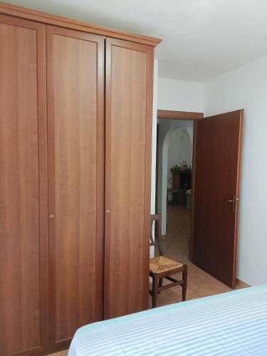 a bedroom with a wooden wardrobe and a bed at Al Poggetto in Gradoli