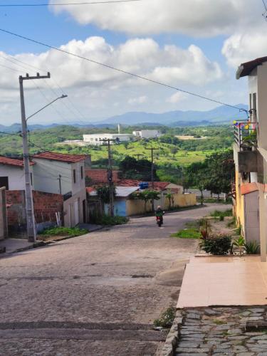 a person riding a motorcycle down a street at Casa próximo ao Centro da cidade in Campina Grande