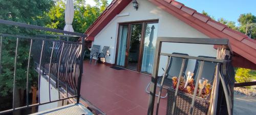 a balcony of a house with a fire place at Mieszkanko z tarasem in Limanowa