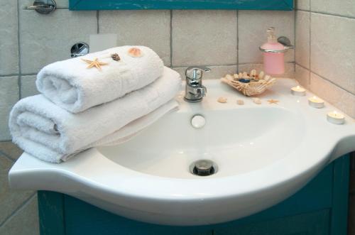 a bathroom sink with towels on top of it at Anastasia Studios in Avlemonas
