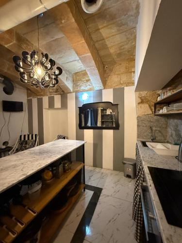 a kitchen with a counter top in a room at Marrone apartment in Valletta