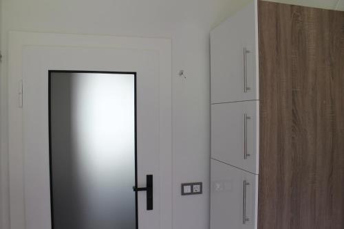 a room with a door and some white cabinets at Ferienwohnung Zum Vierbeiner in Pirna