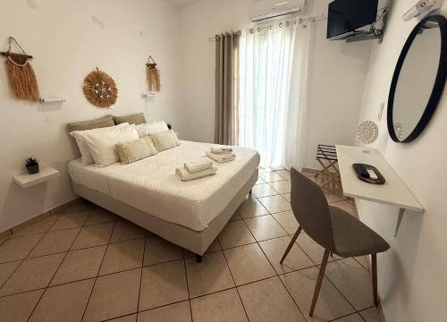 a bedroom with a bed and a mirror and a chair at Fabrika Apartments in Vári
