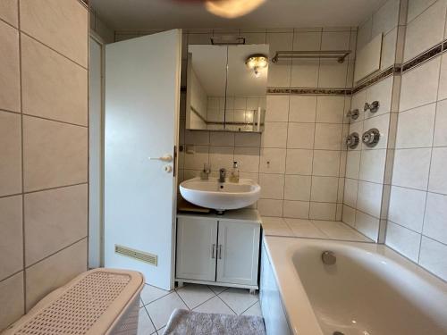 a bathroom with a sink and a bath tub at Herzensnest mit Grüntenblick in Immenstadt in Immenstadt im Allgäu