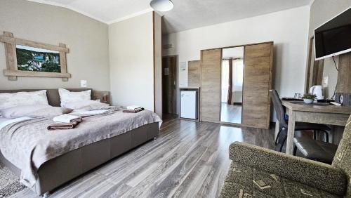 a bedroom with a bed and a desk in a room at SEDRA Holiday Resort-Adults Only-Bed & Breakfast in Grabovac