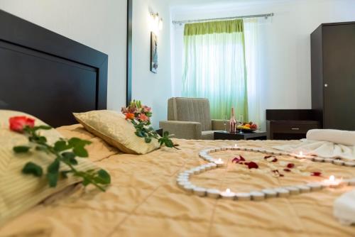a bedroom with a large bed with flowers on it at Gaia Garden in Kos Town