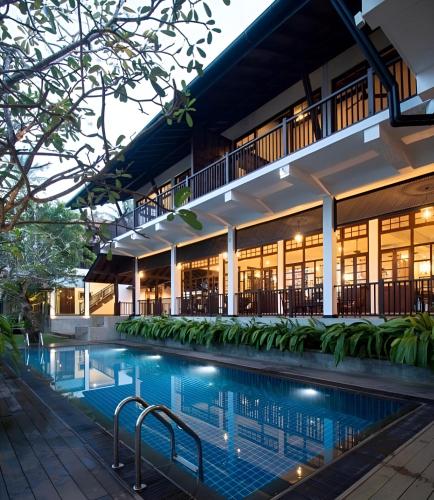 an exterior view of a building with a swimming pool at The Postcard Galle in Galle