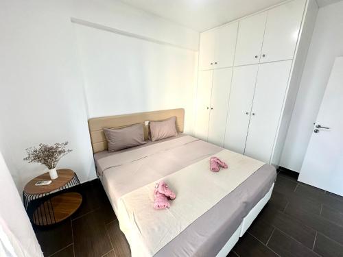 a bedroom with a bed with pink shoes on it at Mediterranean Blue - Secret Escape in Limassol