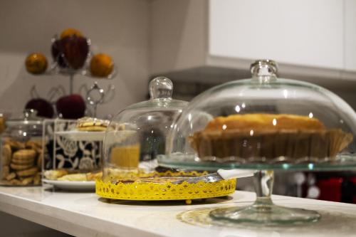 a table with a cake in a glass case at Big Johnny B in Rome