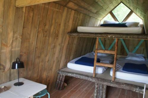 a room with two bunk beds and a desk at Logement insolite L'heureux hasard - van vintage in Contres