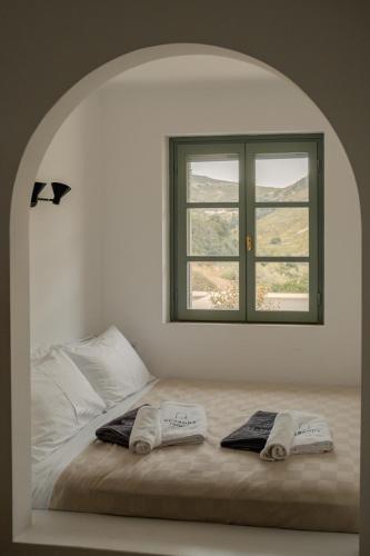 a bedroom with a bed with two towels on it at VERANNA Patmos D3 in Patmos