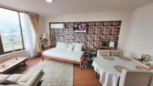 a living room with a bed and a couch at Lindo departamento Edificio Centro Mayor in Temuco