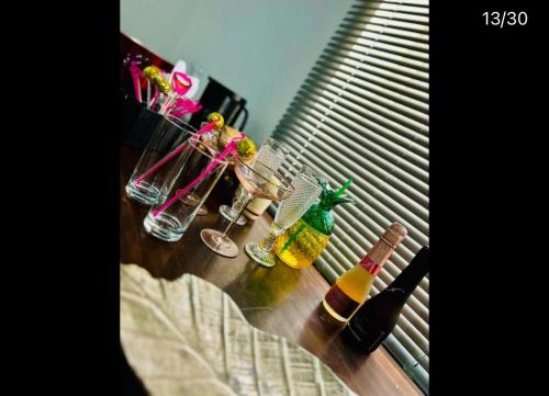 a group of bottles and glasses sitting on a table at Hertford Home detached garden parking pet allowed in Hertford