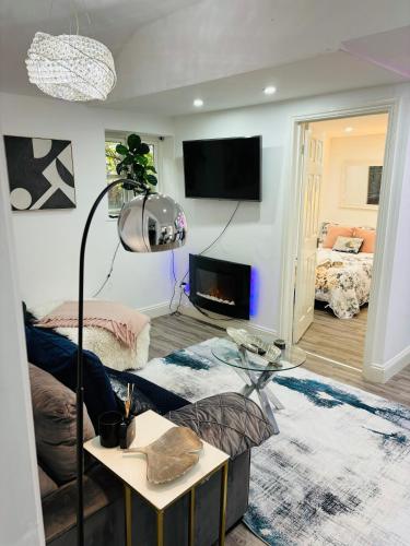 a living room with a couch and a table at Hertford Home detached garden parking pet allowed in Hertford