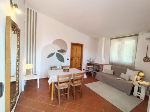 a living room with a couch and a table at L'olivo - Meridiana case al mare in Mattinata