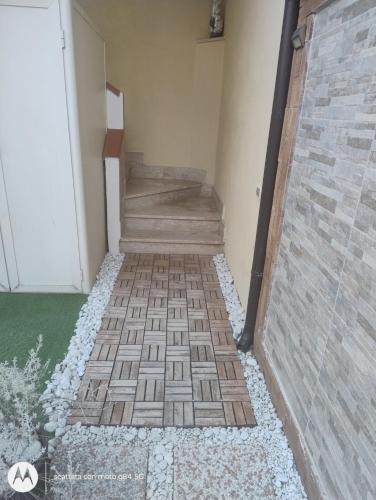 a hallway with a brick floor and stairs at Martina in Santa Maria di Castellabate