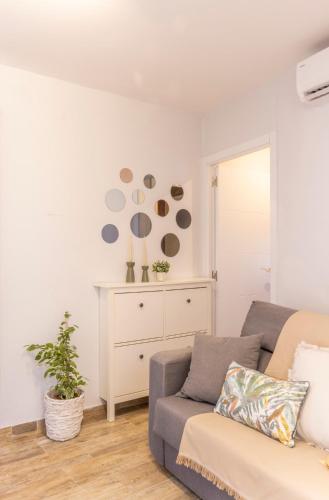 a living room with a couch and a dresser at Apartaments La Cabana in Altafulla