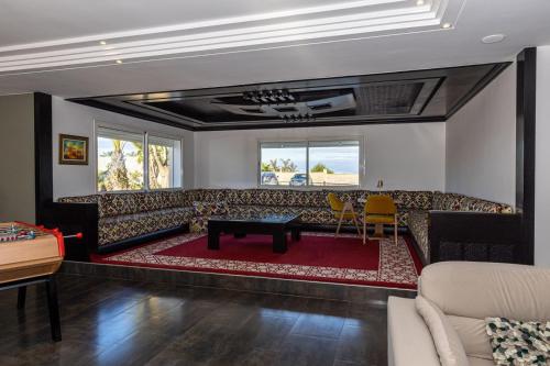 a living room with a couch and a table at Asmae House in Skhirat