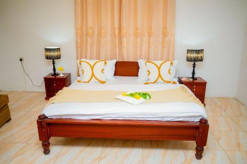 a bedroom with a large wooden bed with two lamps at Malkiya House in Zanzibar City