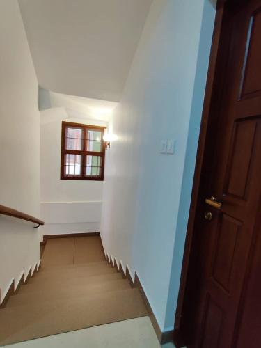 a stairway with a door and a window at Le Zaina's Fort Hotel in Cochin