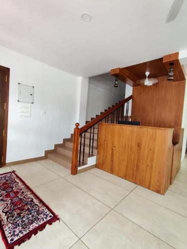 a room with stairs and a rug on the floor at Le Zaina's Fort Hotel in Cochin