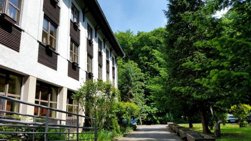 una pasarela junto a un edificio con árboles en Salgó Hotel, en Salgótarján